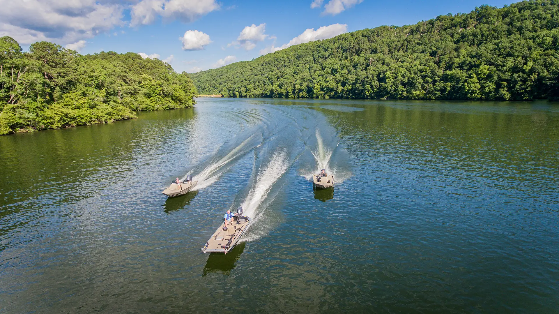 Three Alweld boats cruising on the water