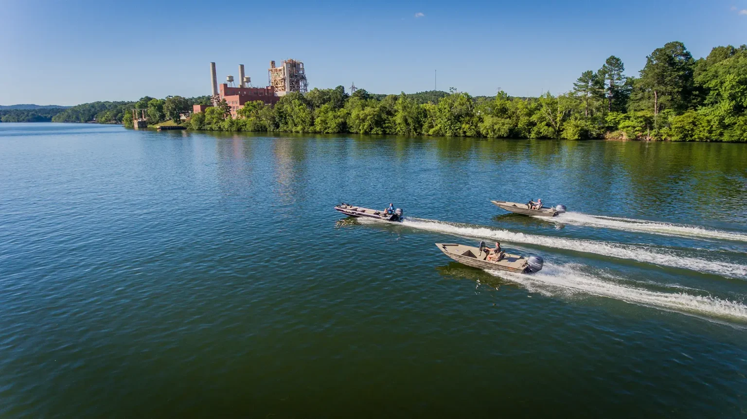 Three Alweld boats cruising on the water