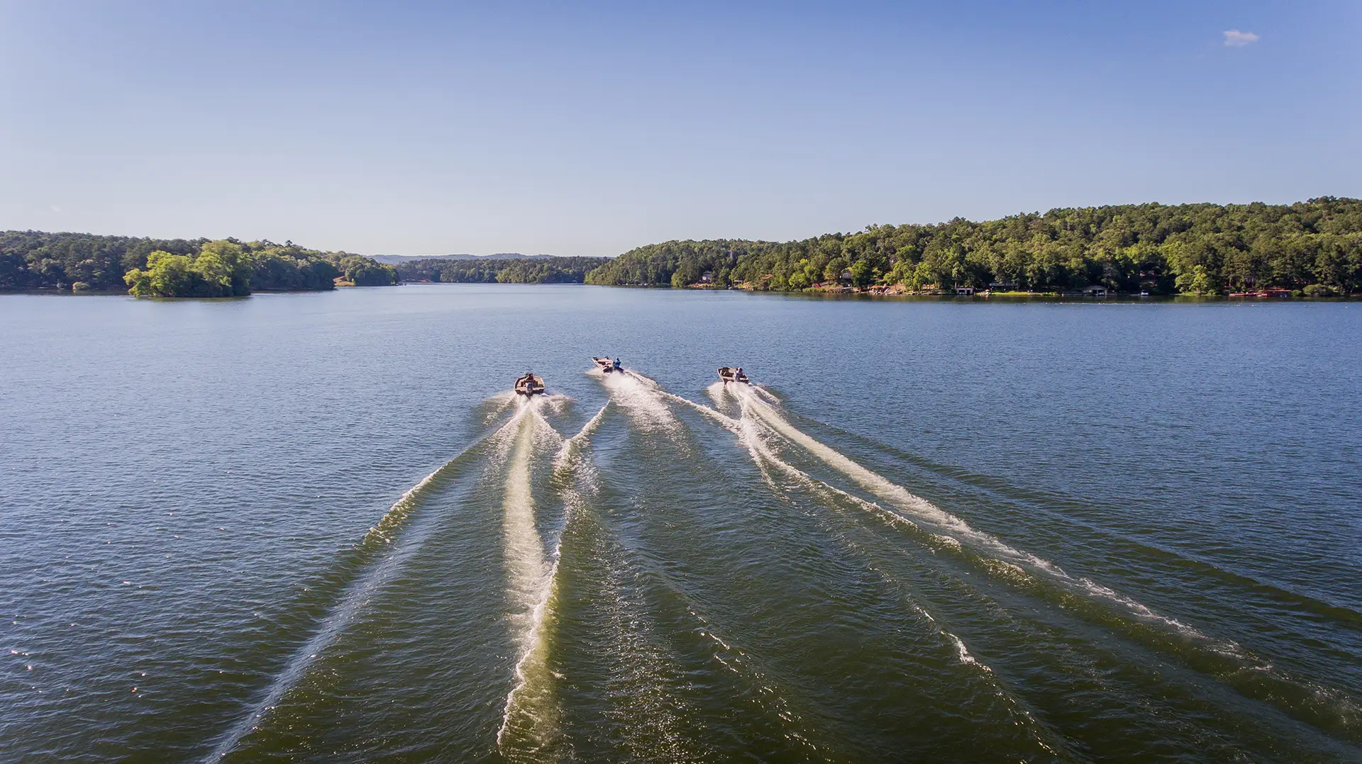 Three Alweld boats cruising on the water