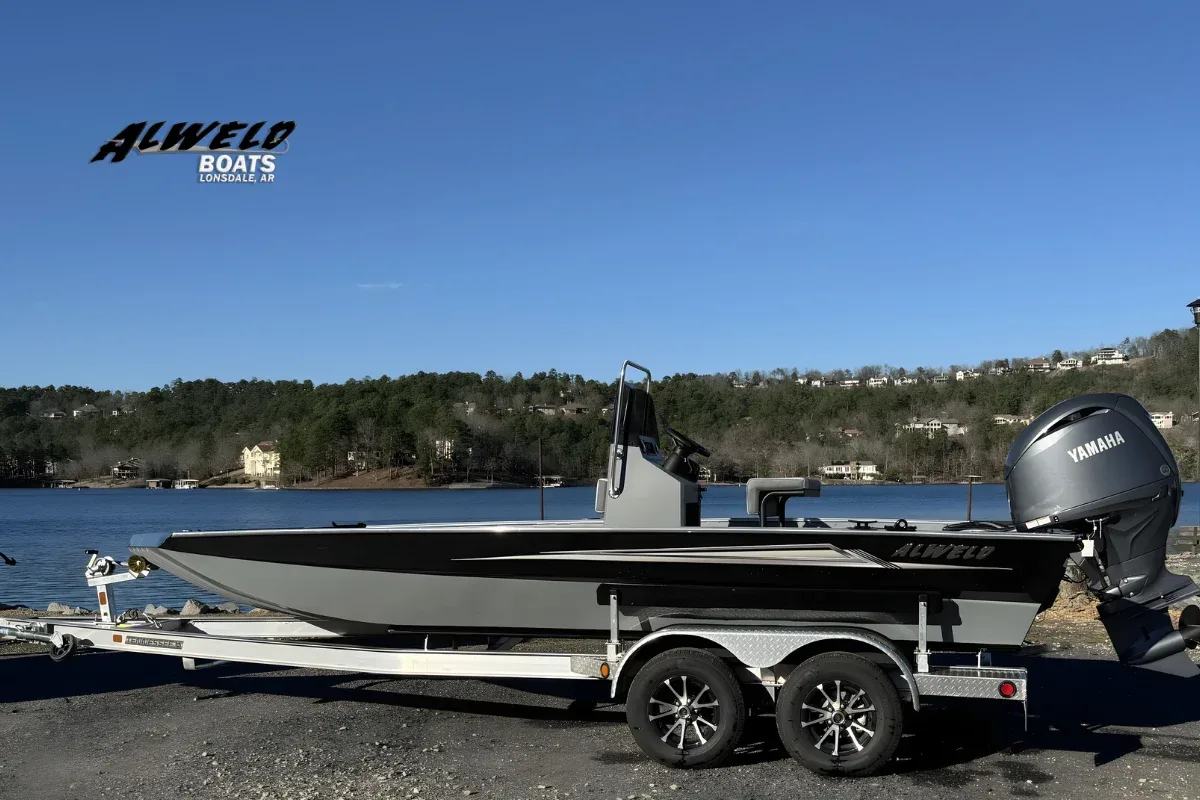 Aluminum boat properly secured on trailer with bow strap and safety chain